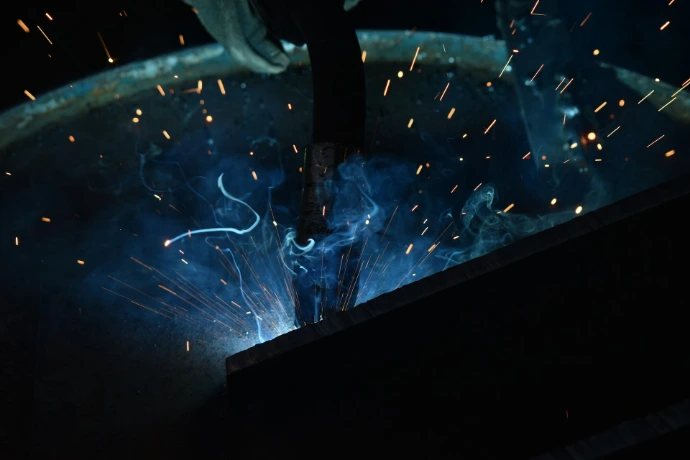 welder working on a piece of metal in a factory